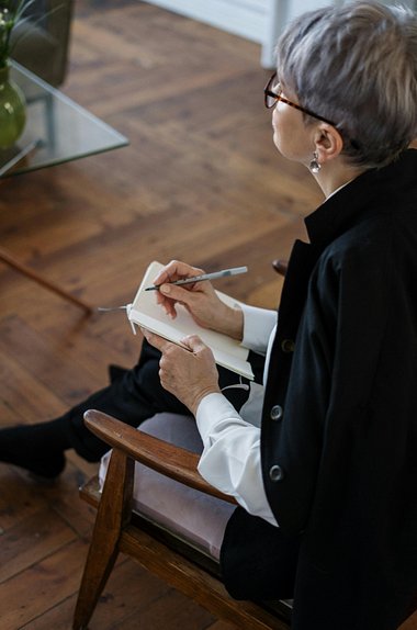 Image of woman writing in notebook